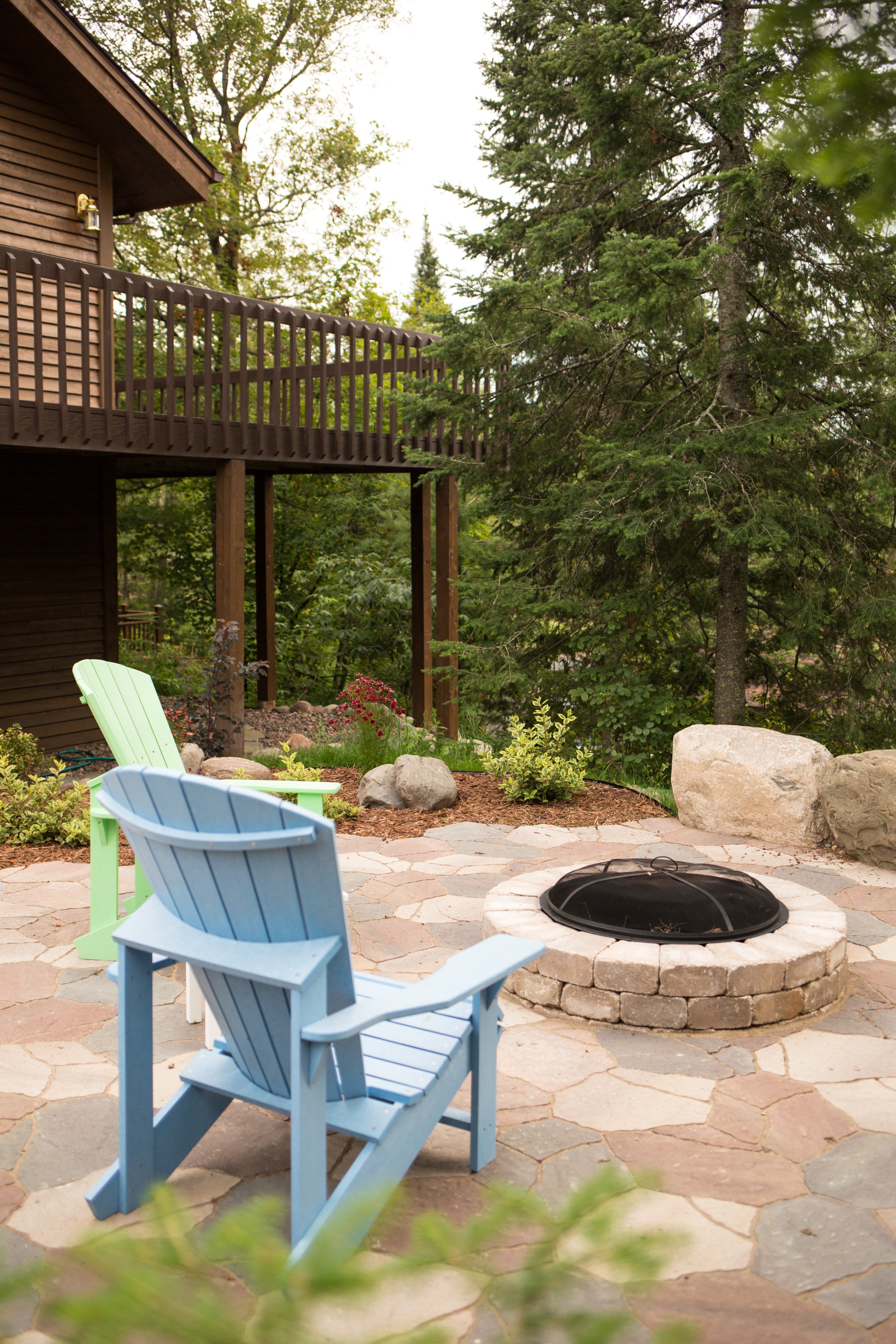 Backyard patio with fire and adirondack chairs