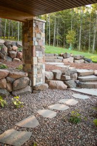 Hillside landscapes with boulder walls and stone stairs